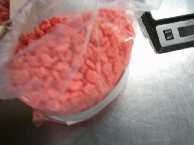 Open clear bag of Franken Berry cereal with weight scale next to it.